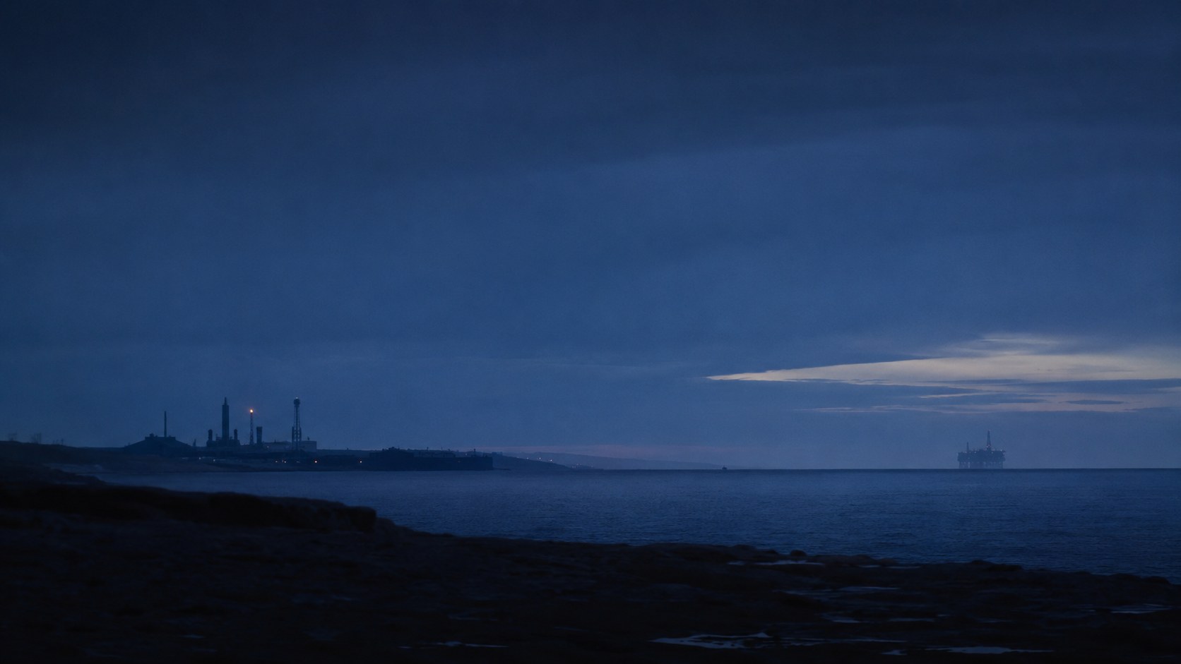An integrated offshore oil and gas field at dusk